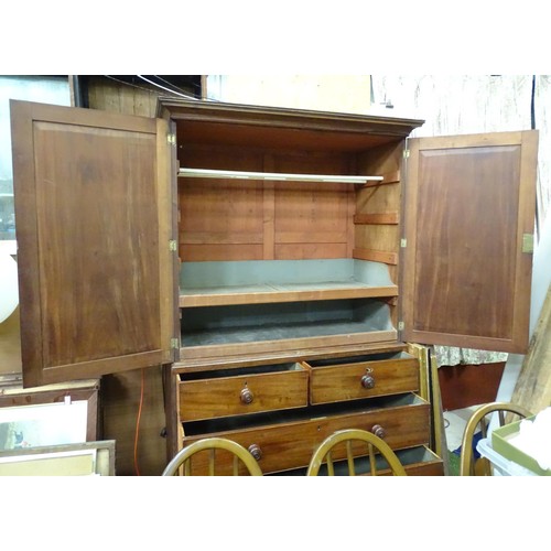 338 - An early 19thC mahogany linen press, having a moulded cornice above two panelled doors and the base ... 