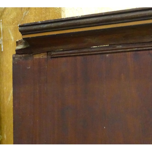 338 - An early 19thC mahogany linen press, having a moulded cornice above two panelled doors and the base ... 
