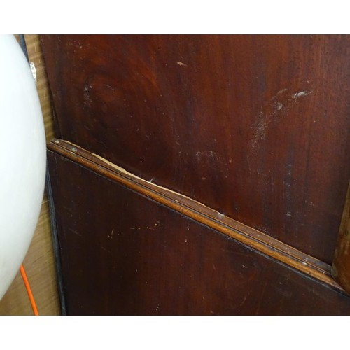 338 - An early 19thC mahogany linen press, having a moulded cornice above two panelled doors and the base ... 