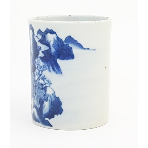 39 - A Chinese blue and white brush pot of cylindrical form decorated with a mountain landscape. Approx. ... 