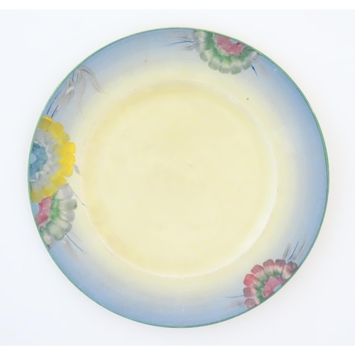 84 - A Clarice Cliff plate decorated with a floral border. Marked under. Approx. 10