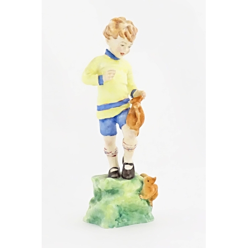 112A - A Royal Worcester figure depicting a boy with two squirrels, titled October from the Months of the Y... 