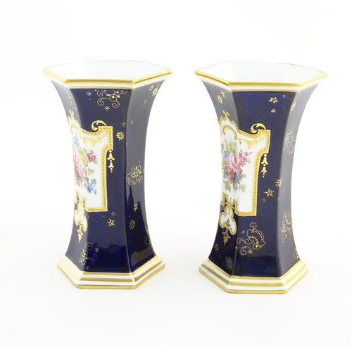 197 - A pair Royal Crown Derby vases of hexagonal flared form with hand painted floral vignettes signed G.... 