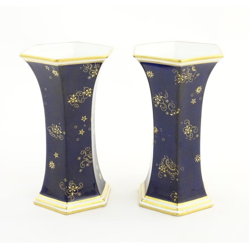 197 - A pair Royal Crown Derby vases of hexagonal flared form with hand painted floral vignettes signed G.... 