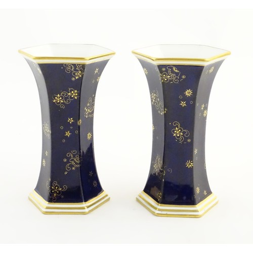 197 - A pair Royal Crown Derby vases of hexagonal flared form with hand painted floral vignettes signed G.... 