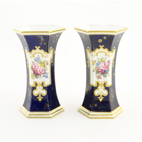 197 - A pair Royal Crown Derby vases of hexagonal flared form with hand painted floral vignettes signed G.... 