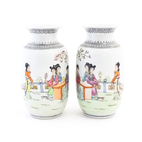 2 - A pair of Japanese vases decorated with female figures in a garden landscape, three ladies seated un... 
