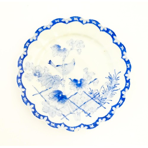 4 - A Japanese blue and white plate with scalloped edge, decorated with a bird perched on a branch with ... 