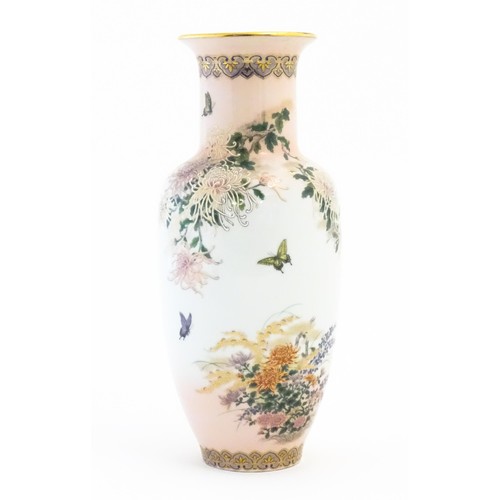 6 - A Japanese vase in the Kyoto pattern decorated with chrysanthemum flowers, butterflies, etc. Marked ... 