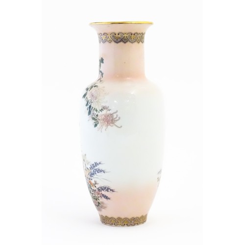 6 - A Japanese vase in the Kyoto pattern decorated with chrysanthemum flowers, butterflies, etc. Marked ... 