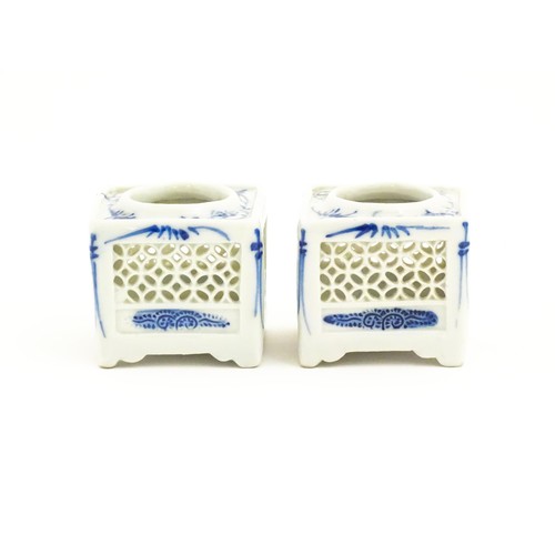 13 - Two Chinese ink pot stands of squared form with reticulated sides and blue brushwork detail. Approx.... 