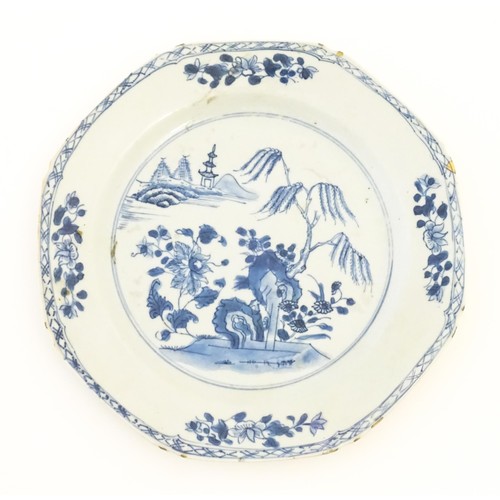 18 - A Chinese blue and white plate of octagonal form decorated with a landscape with flowers, trees and ... 