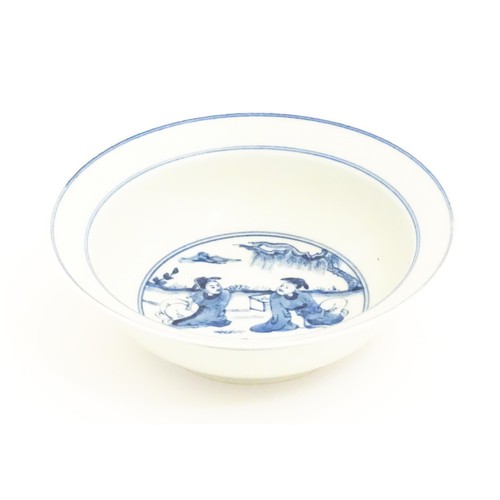 22 - A Chinese blue and white bowl, the centre decorated with two seated figures in a garden landscape. C... 