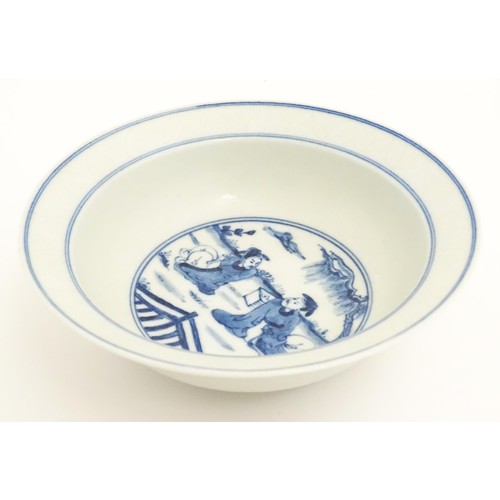 22 - A Chinese blue and white bowl, the centre decorated with two seated figures in a garden landscape. C... 