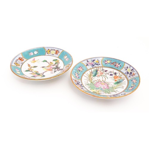 33 - Two Oriental dishes, one decorated with a bird perched on a peach branch with a butterfly, the turqu... 