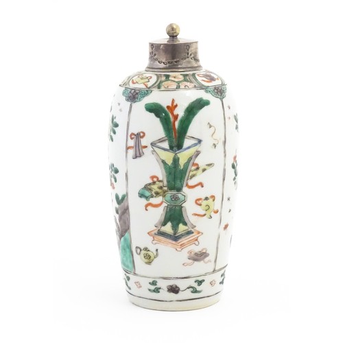 34 - A Chinese famille verte jar of ovoid form with white metal mount and top, the body with panelled dec... 