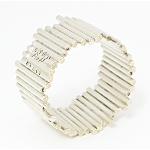 504 - An Elizabeth II silver napkin ring of modernist form, hallmarked London 1976, maker M. B.