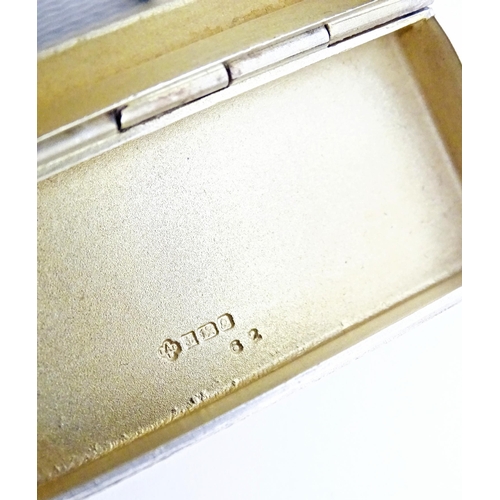 518 - A small silver box with engine turned decoration and gilded interior. Hallmarked Birmingham 1990, ma... 