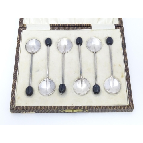 592 - A cased set of six coffee spoons with coffee bean decoration to handle. hallmarked Birmingham 1929 m... 