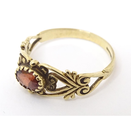 665 - A 9ct gold ring set with central garnet. Ring size approx M