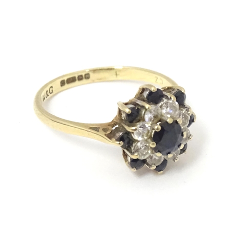 666 - A 9ct gold ring set with sapphires and white stones in a cluster setting. Ring size approx. M 1/2