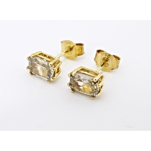 759 - A 9ct gold pendant set with csarite, together with a pair of matching stud earrings. The pendant on ... 