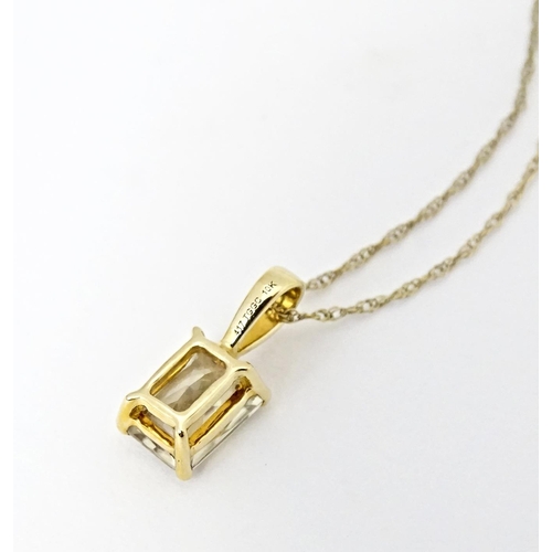 759 - A 9ct gold pendant set with csarite, together with a pair of matching stud earrings. The pendant on ... 