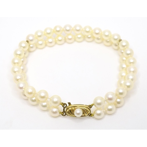 764 - A two strand pearl bracelet with 9ct gold clasp. Approx 7 1/2