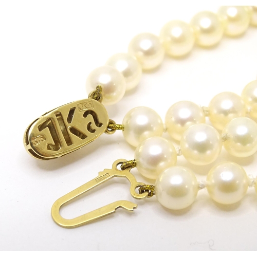 764 - A two strand pearl bracelet with 9ct gold clasp. Approx 7 1/2