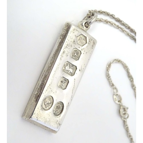 765 - A silver Charles and Diana commemorative / souvenir pendant of ingot form hallmarked Sheffield 1981,... 