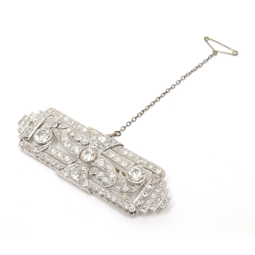 774 - An impressive Art Deco white metal brooch set with a profusion of diamonds. The two largest diamonds... 