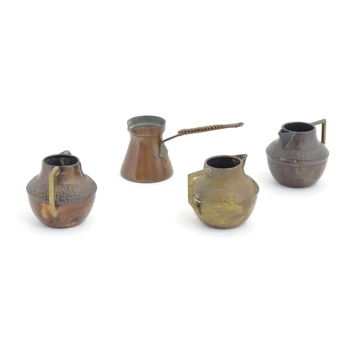 1098 - Three Arts & Crafts copper jugs with hammered decoration based on a designed by Christopher Dresser.... 