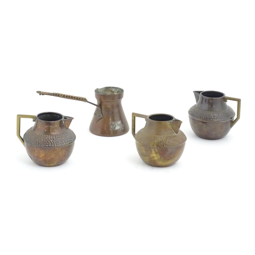 1098 - Three Arts & Crafts copper jugs with hammered decoration based on a designed by Christopher Dresser.... 