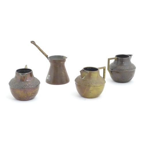 1098 - Three Arts & Crafts copper jugs with hammered decoration based on a designed by Christopher Dresser.... 