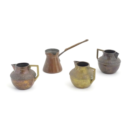 1098 - Three Arts & Crafts copper jugs with hammered decoration based on a designed by Christopher Dresser.... 