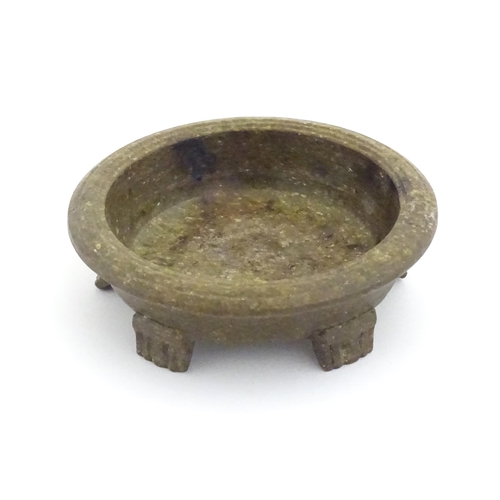 1128 - An Oriental stone dish with reeded rim and mica style decoration standing on five feet. Approx. 4