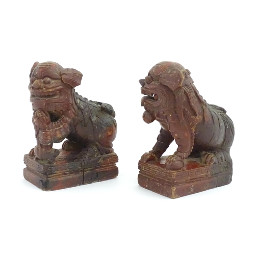 1144 - Two Chinese carved wooden foo dogs / guardian lions, one with a cub, the other with a ball, with tra... 