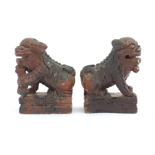 1144 - Two Chinese carved wooden foo dogs / guardian lions, one with a cub, the other with a ball, with tra... 