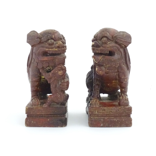 1144 - Two Chinese carved wooden foo dogs / guardian lions, one with a cub, the other with a ball, with tra... 