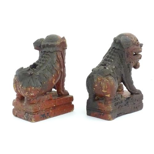 1144 - Two Chinese carved wooden foo dogs / guardian lions, one with a cub, the other with a ball, with tra... 