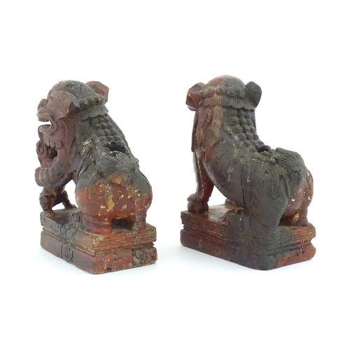 1144 - Two Chinese carved wooden foo dogs / guardian lions, one with a cub, the other with a ball, with tra... 