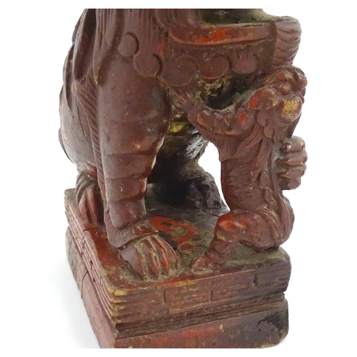 1144 - Two Chinese carved wooden foo dogs / guardian lions, one with a cub, the other with a ball, with tra... 