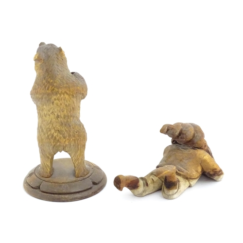 1160 - A 20thC Black Forest carved model of a bear. Together with a carved model of a recumbent gnome. Appr... 