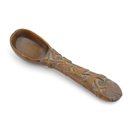 1165 - A Victorian carved wooden treen spoon with stylised vine leaf decoration, signed J. J. 1889 under. A... 