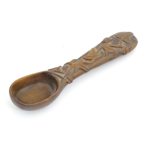 1165 - A Victorian carved wooden treen spoon with stylised vine leaf decoration, signed J. J. 1889 under. A... 