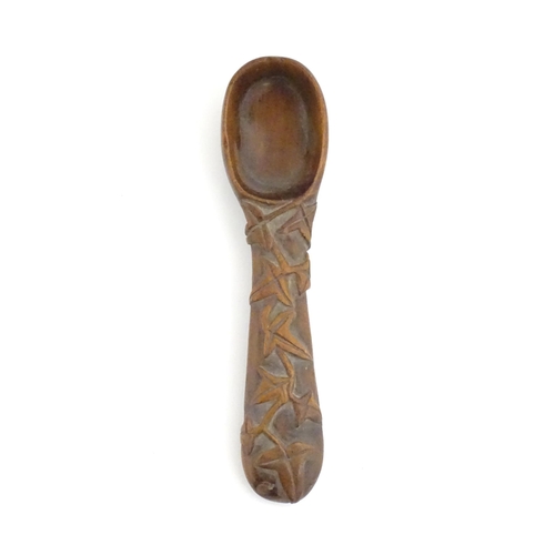 1165 - A Victorian carved wooden treen spoon with stylised vine leaf decoration, signed J. J. 1889 under. A... 