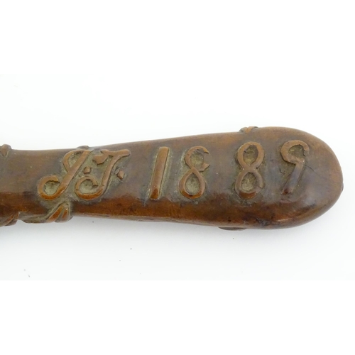 1165 - A Victorian carved wooden treen spoon with stylised vine leaf decoration, signed J. J. 1889 under. A... 