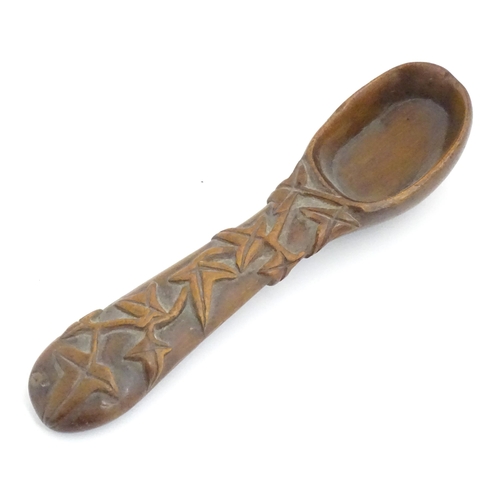 1165 - A Victorian carved wooden treen spoon with stylised vine leaf decoration, signed J. J. 1889 under. A... 