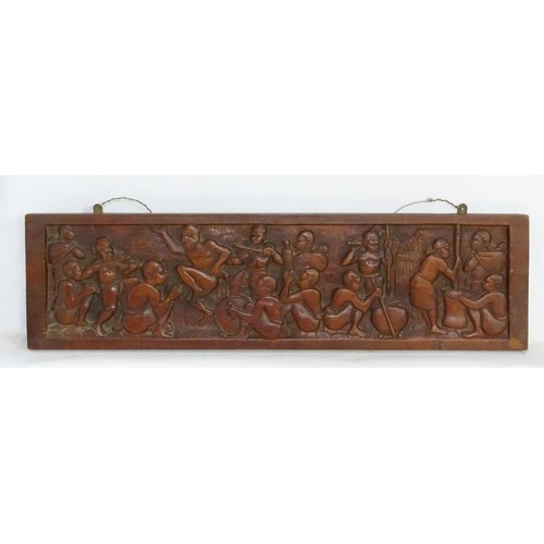 1181 - Ethnographic, Native, Tribal : A 20thC carved hardwood panel by Joseph Rasola depicting figures danc... 