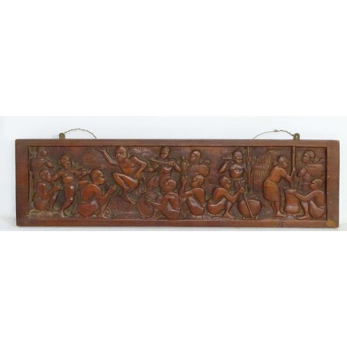 1181 - Ethnographic, Native, Tribal : A 20thC carved hardwood panel by Joseph Rasola depicting figures danc... 